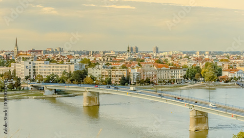 A panoramic city view of Novi Sad with its iconic bridge over the Danube River is a breathtaking sight. From this vantage point, the city sprawls beneath the sky, with the elegant Varadin Bridge