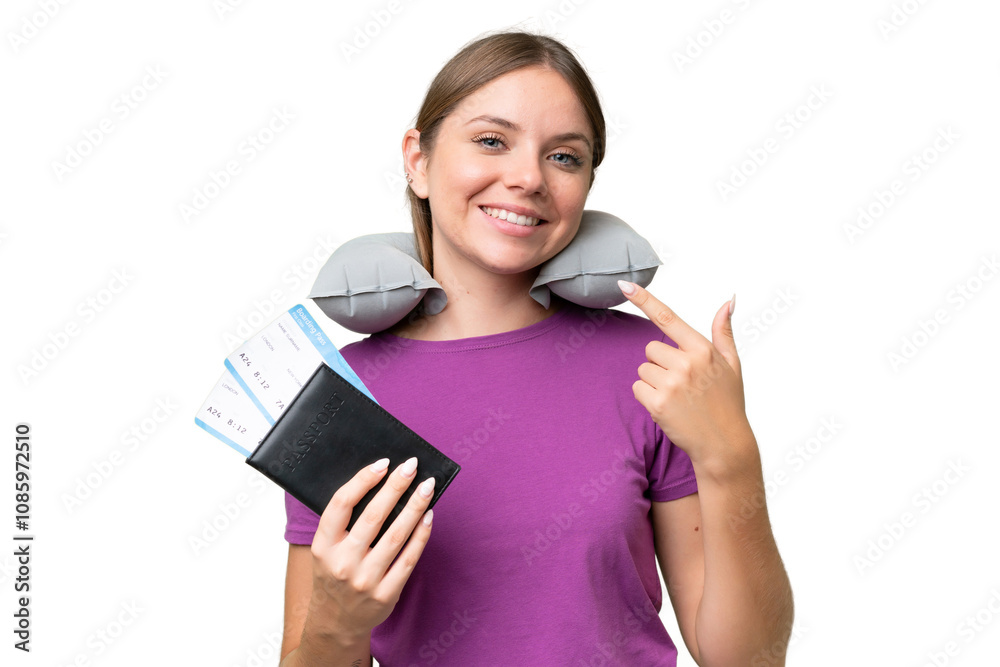 Young beautiful blonde woman with Inflatable travel Pillow over isolated background giving a thumbs up gesture Young beautiful blonde woman with Inflatable travel Pillow over isolated background giving a thumbs up gesture