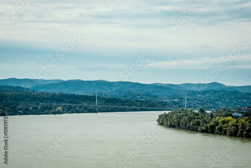 The fortress perched on Petrovaradin Hill watches over the city, while the charming streets and modern buildings of Novi Sad are spread out, creating a perfect blend of history and contemporary life photo