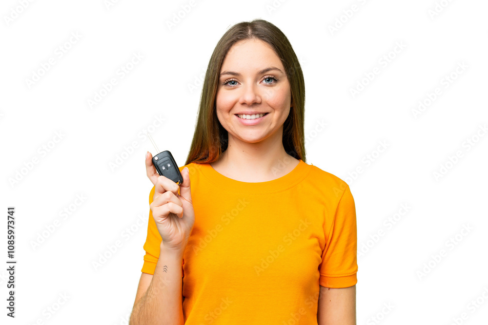 Young woman holding car keys over isolated chroma key background smiling a lot Young woman holding car keys over isolated chroma key background smiling a lot