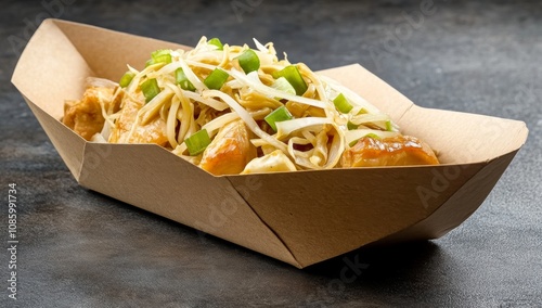 Brown Kraft Paper Box of Chinese Food with Chicken and Vegetables on a Black Table photo