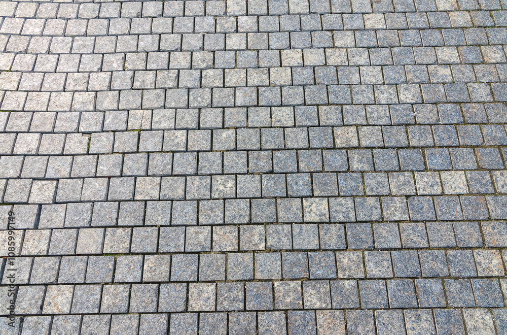 Stone block pavement in the rays of the setting sun. Texture Stone block pavement in the rays of the setting sun. Texture