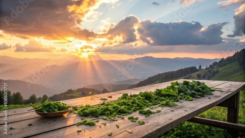 Freshly harvested greens on a rustic table at sunset photo