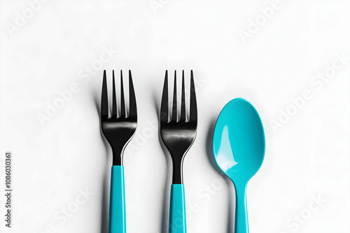 Set of Black Cutlery with Aqua Handles Featuring Forks and Spoon on a Minimalistic White Background for Modern Dining Aesthetics