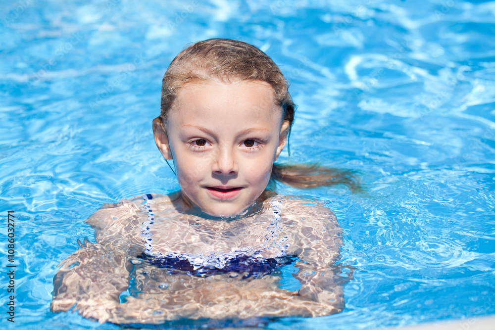 Child girl in blue bikini near swimming pool. Hot Summer Child girl in blue bikini near swimming pool. Hot Summer