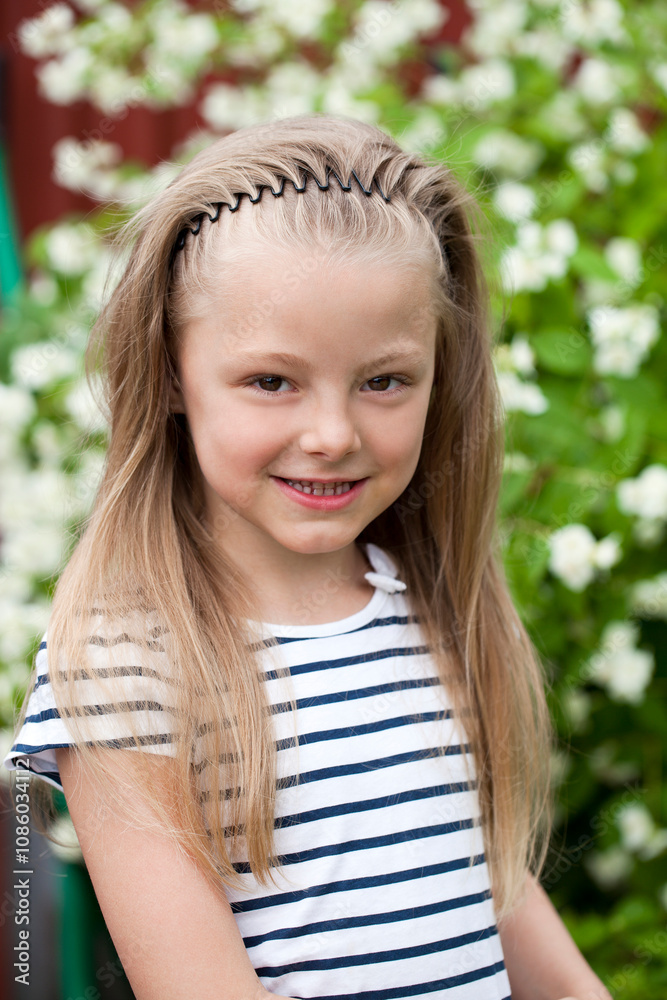 Close up portrait of a seven year little girl, against background of summer park Close up portrait of a seven year little girl, against background of summer park