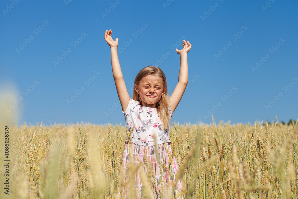 Little girl posing in a wheat field Little girl posing in a wheat field
