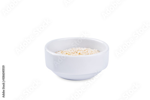 Sesame seeds in a white bowl on a white isolated background