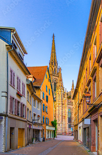 Old town Mulhouse city historic centre with pedestrian street, old colorful buildings, typical multicolored houses and Temple Saint-Etienne church Mulhouse Cathedral, Alsace Grand Est region, France