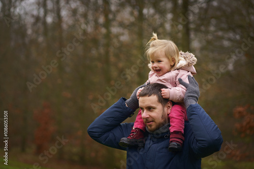 A touching moment of father and daughter sharing a playful day in the park, perfect for content about family relationships, childhood memories, or promoting family-friendly products and services.