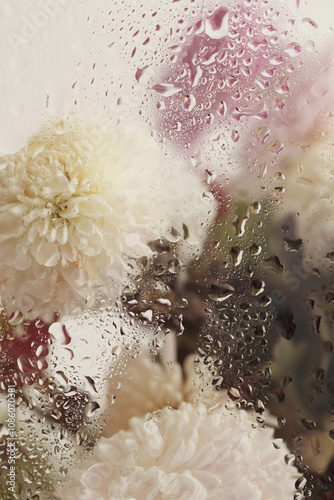 Soft focus  flower bouquet through glass with wet water drops. Abstract nature blur background. photo