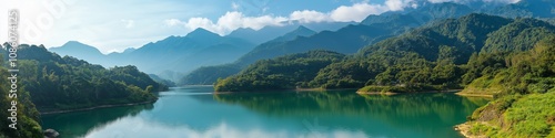 A beautiful mountain range with a lake in the middle. The lake is calm and peaceful, reflecting the mountains in the distance. The scene is serene and picturesque, with the mountains