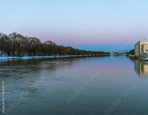 A calm river with a beautiful blue sky in the background