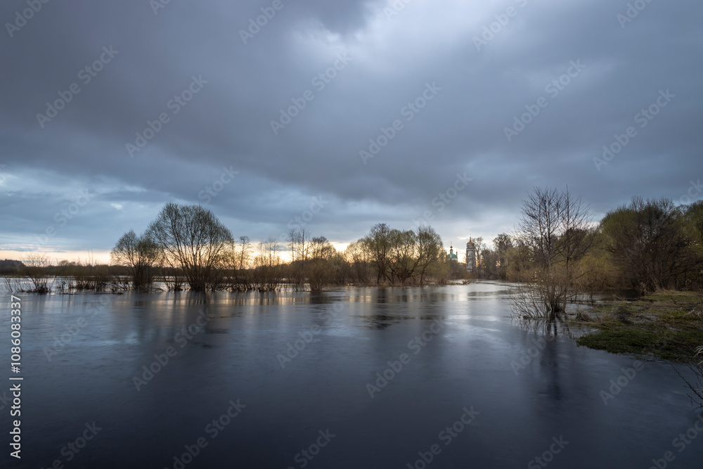 Cloudy sky with a lake in the foreground Cloudy sky with a lake in the foreground
