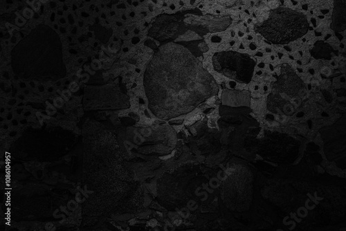 Abstract black and white stone background with stone wall texture in the dark