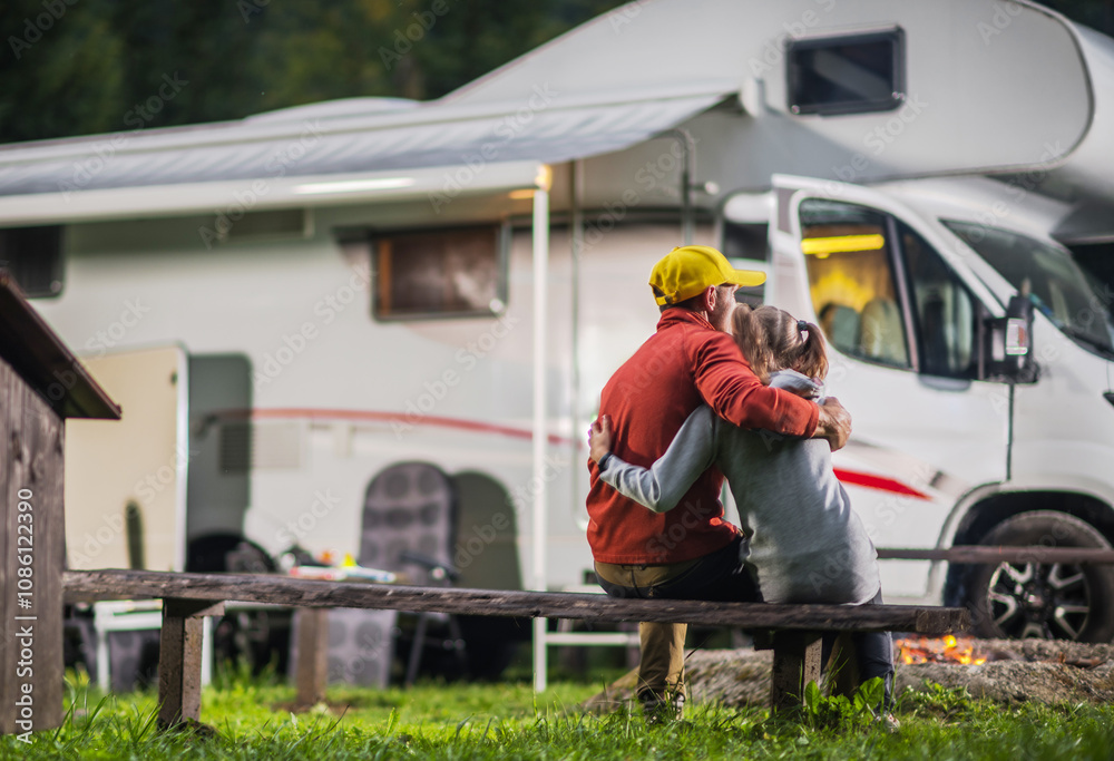Fototapeta premium Father and His Daughter Enjoys a Cozy Evening by Their Camper Van on a Wooden Bench