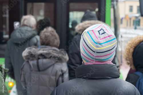 Freezing people in line at bus stop