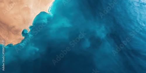 A shot of a desert landmass next to an ocean
