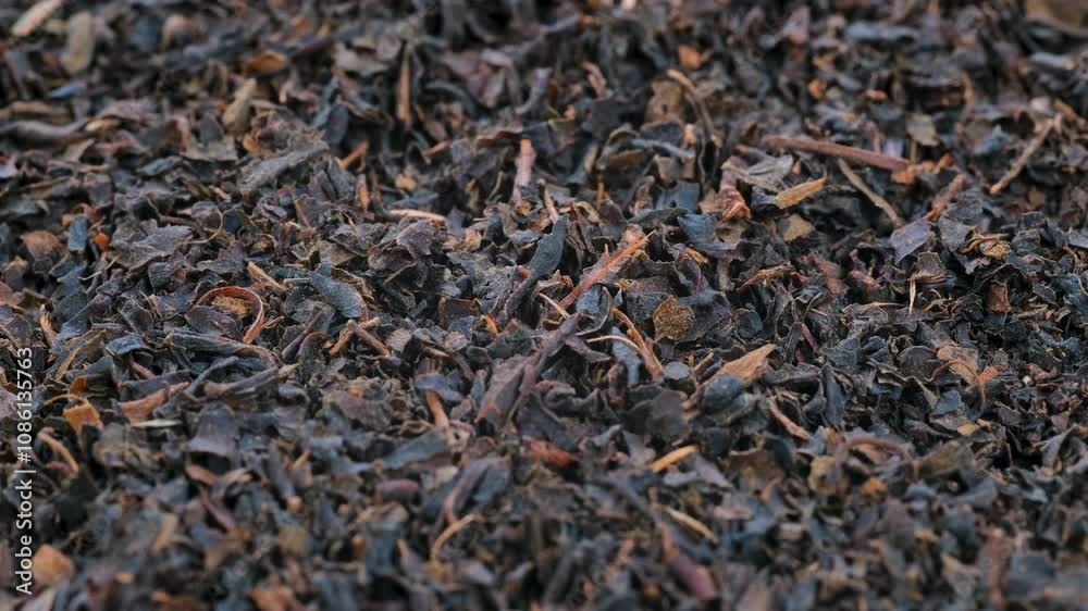 Top view, macro. Heap of ground dried black tea leaves, slider shot. Shallow depth of field, selective focus. Ingredients, beverage, flavor, tea-related themes. 4k. Top view, macro. Heap of ground dried black tea leaves, slider shot. Shallow depth of field, selective focus. Ingredients, beverage, flavor, tea-related themes. 4k.