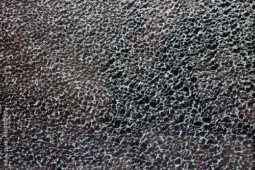 Decorative glass with cracked pattern, on black background. Not an illustration