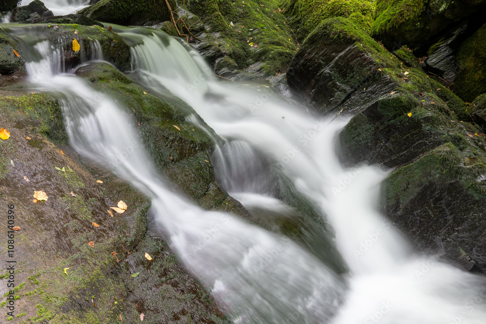 Long exposure of a waterfall on the Hoar Oak Water river at Watersmeet in Exmoor National Park Long exposure of a waterfall on the Hoar Oak Water river at Watersmeet in Exmoor National Park