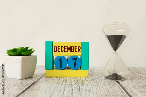 Wooden calendar of December 17 date standing in the snow in nature