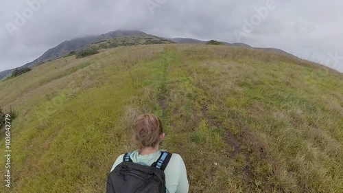 Overhead of Woman Hiking Across Grassy Field in Channel Islands National Park photo