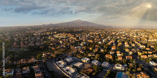 Aerial View of Catania City with the Majestic Mount Etna Volcano in the Background — Stunning Panorama of Sicilian Urban Landscape and Iconic Volcanic Scenery at Sunset photo