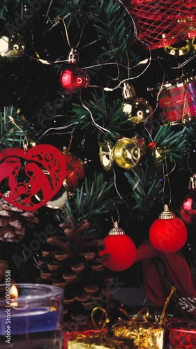 Close up of decorated Christmas tree with twinkling lights, vertical video, details. Scene background.