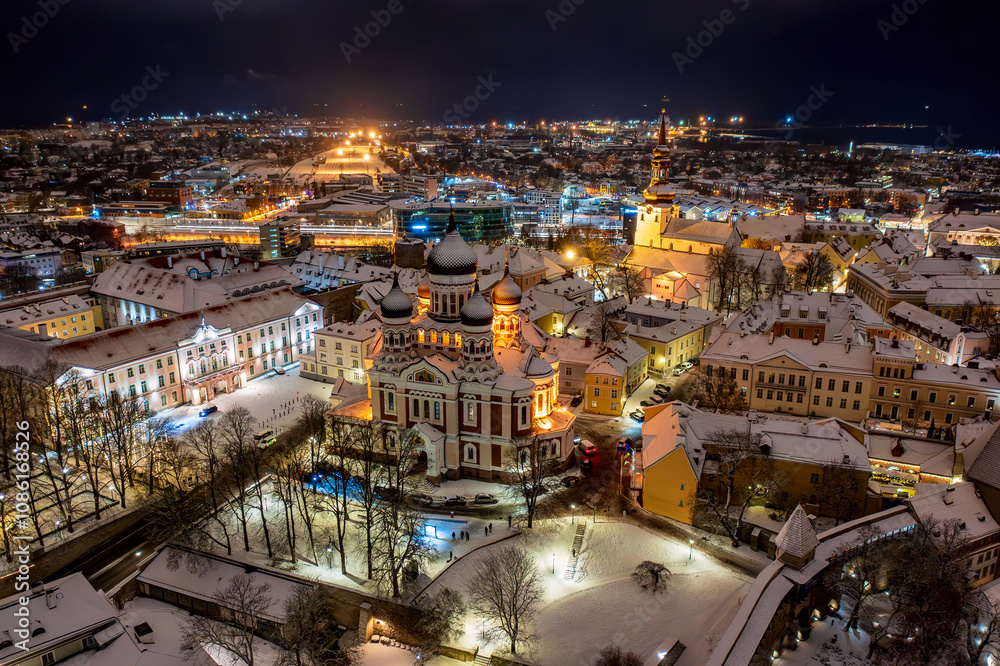 Fototapeta premium Aerial night View of Tallinn in winter with Alexander Nevsky Cathedral, roofs with snow, Christmas mood