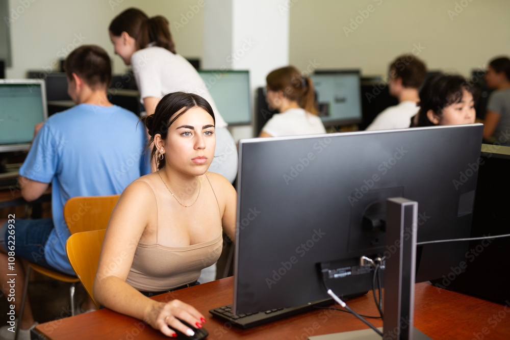 Teenager girl using computer during computer sciene lesson in school. Teenager girl using computer during computer sciene lesson in school.