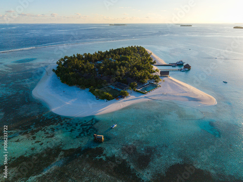 Aerial views of Velavaru Island at sunset in Maldives photo