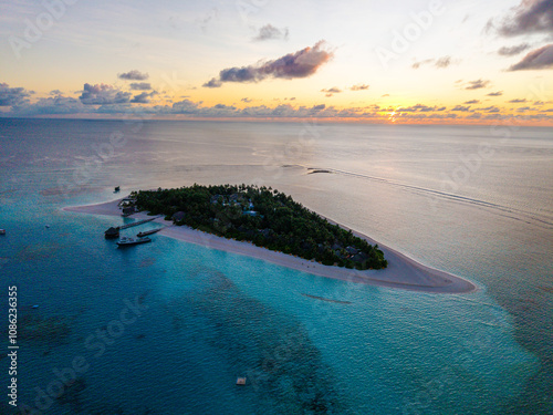 Aerial views of Velavaru Island at sunset in Maldives photo