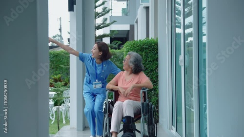 caregiver is caring for an elderly person in a wheelchair in a nursing home.
