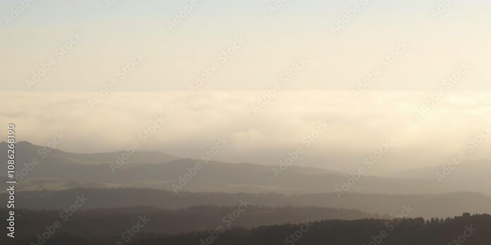 Fototapeta premium Dense fog bank hovers above vast landscape, haze, weather phenomena