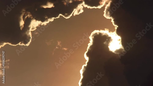 silhouette of yellowish clouds as the sun begins to set