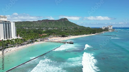 Still shot of Kuhio Beach with breakwater at the edge of Waikiki with Diamond Head in the background in Honolulu on Oahu, Hawaii	 photo