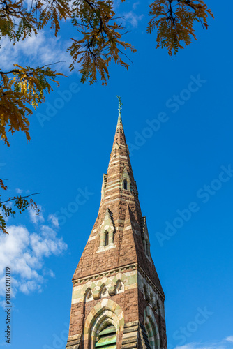 Tall Gothic steeple of United Parish against a clear blue sky in Brookline, Massachusetts, USA
 photo