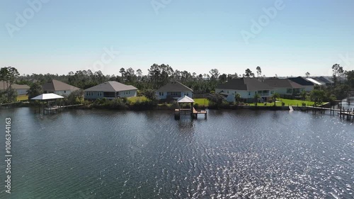 Wallpaper Mural Flying Away From Boat House Lifts With Waterfront Houses By The Lake In Panama City Beach, Florida, USA. - aerial pullback shot Torontodigital.ca