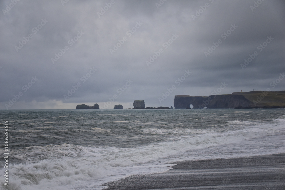Reynisfjara black-sand beach found on the Ocean South Coast of Iceland, basalt columns and the dramatic Reynisdrangar sea stacks. Iceland, Europe. Reynisfjara black-sand beach found on the Ocean South Coast of Iceland, basalt columns and the dramatic Reynisdrangar sea stacks. Iceland, Europe.