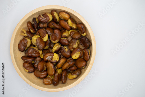 Koro beans in a wooden bowl on a white background photo