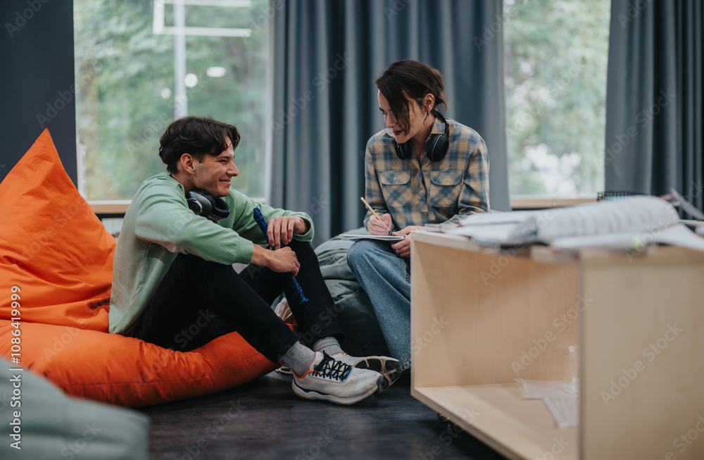 Obraz premium Two college students are engaged in a music class, sitting with instruments and sharing creative ideas together in an informal, relaxed setting.