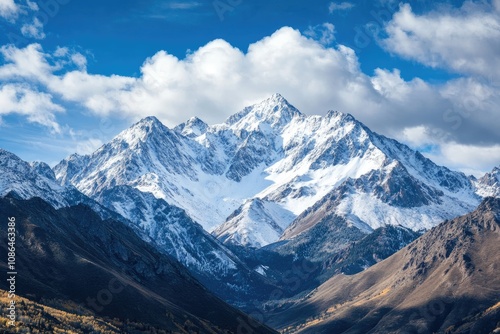 Majestic Snow-Capped Mountain Range Under a Cloudy Sky