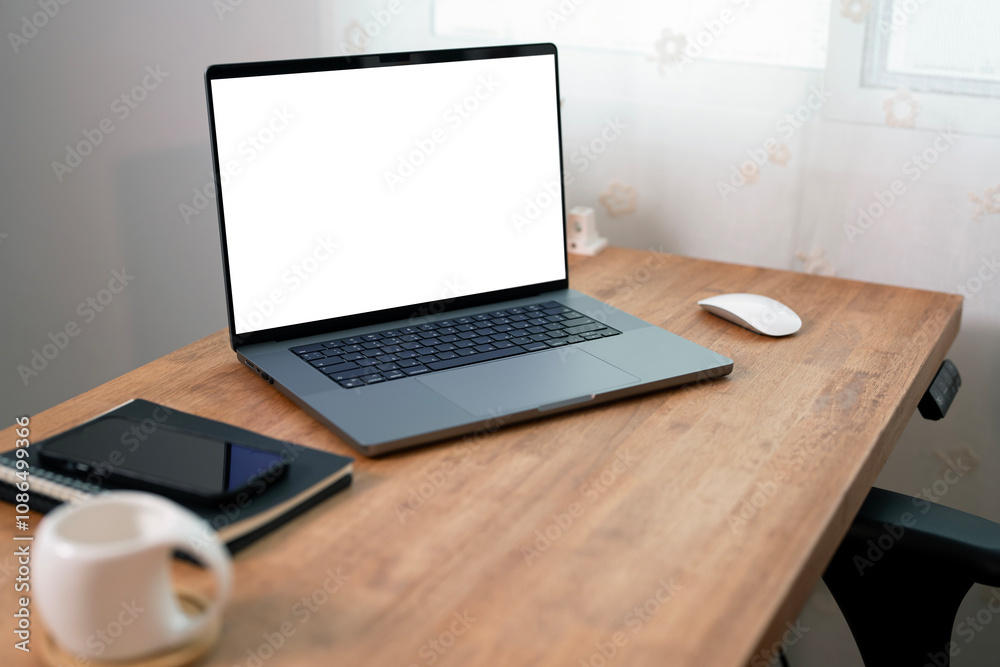Open laptop with blank screen on a wooden desk in a kitchen room home office Open laptop with blank screen on a wooden desk in a kitchen room home office