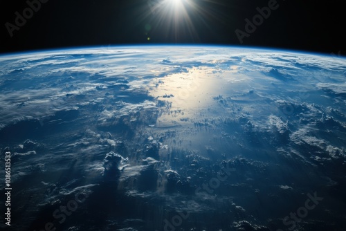 Earth viewed from space with the sun rising over the horizon.