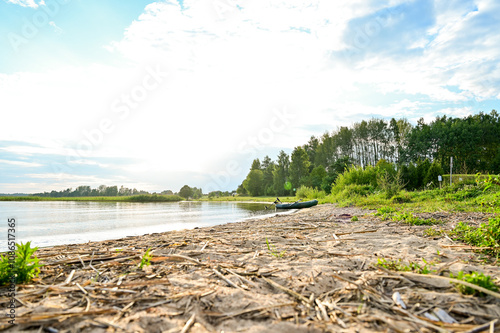 Fototapeta Naklejka Na Ścianę i Meble -  Beautiful evening atmosphere at sunset on the beach of Lake Razna, Raznas ezers, the largest lake in Latvia with panorama over the water, beach and forest in the background, Latgale, Latvia