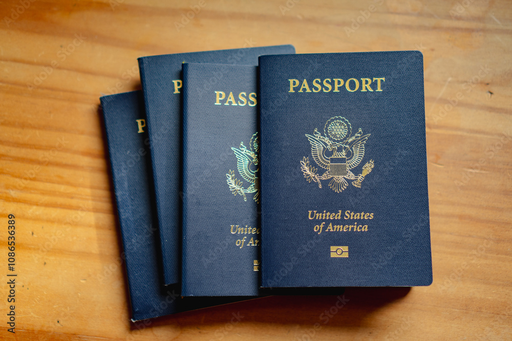 Stack of USA passports on wood table Stack of USA passports on wood table