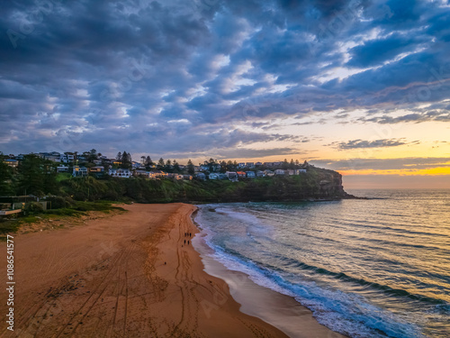 Pretty Sunrise at the seaside with rain clouds photo