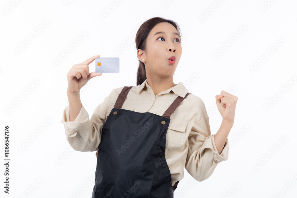 Portrait happiness young asian woman wearing apron holding credit card isolated white background, barista or waitress showing debit card for purchase or shopping online and payment, small business. Portrait happiness young asian woman wearing apron holding credit card isolated white background, barista or waitress showing debit card for purchase or shopping online and payment, small business.