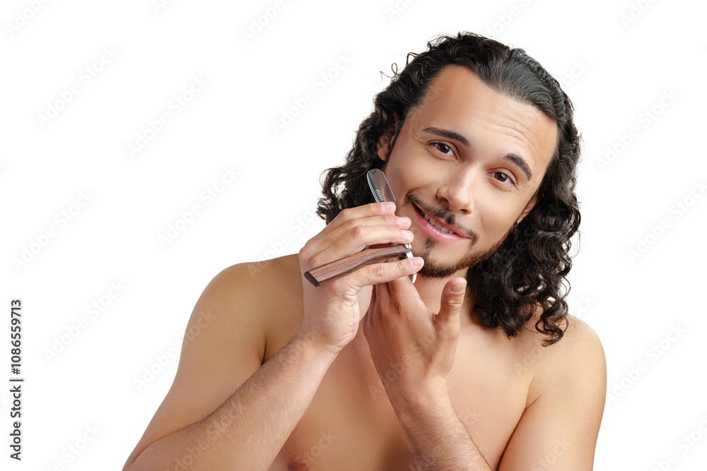 A man with curly hair grooming his beard in a well-lit space while using a straight razor A man with curly hair grooming his beard in a well-lit space while using a straight razor